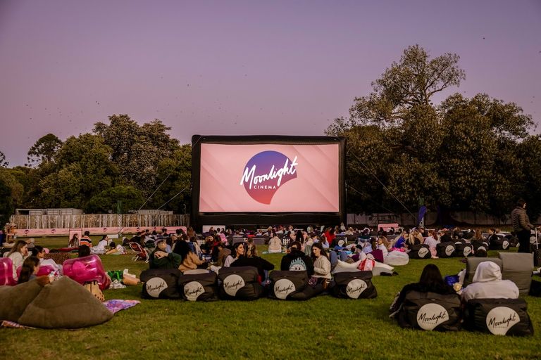 Crowd on beanbags watching an outdoor movie screening at Moonlight Cinema in Botanic Park, Adelaide.